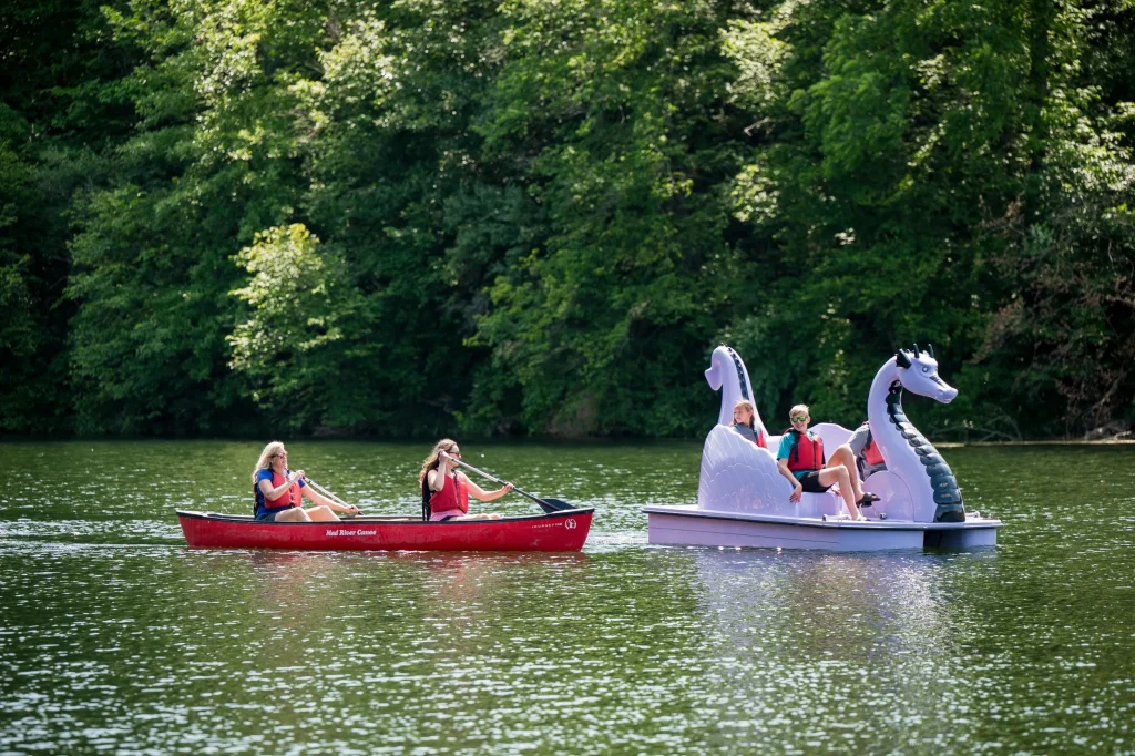People in canoe and pedal boat on water
